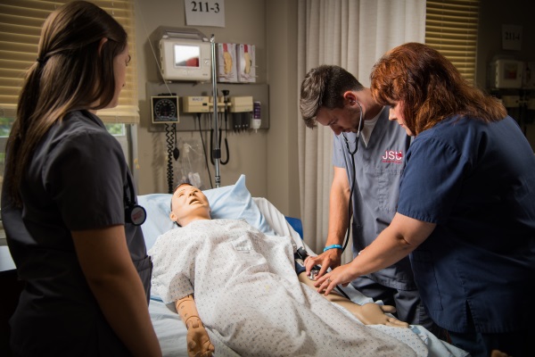 Dr. Duckett with students in nursing arts lab